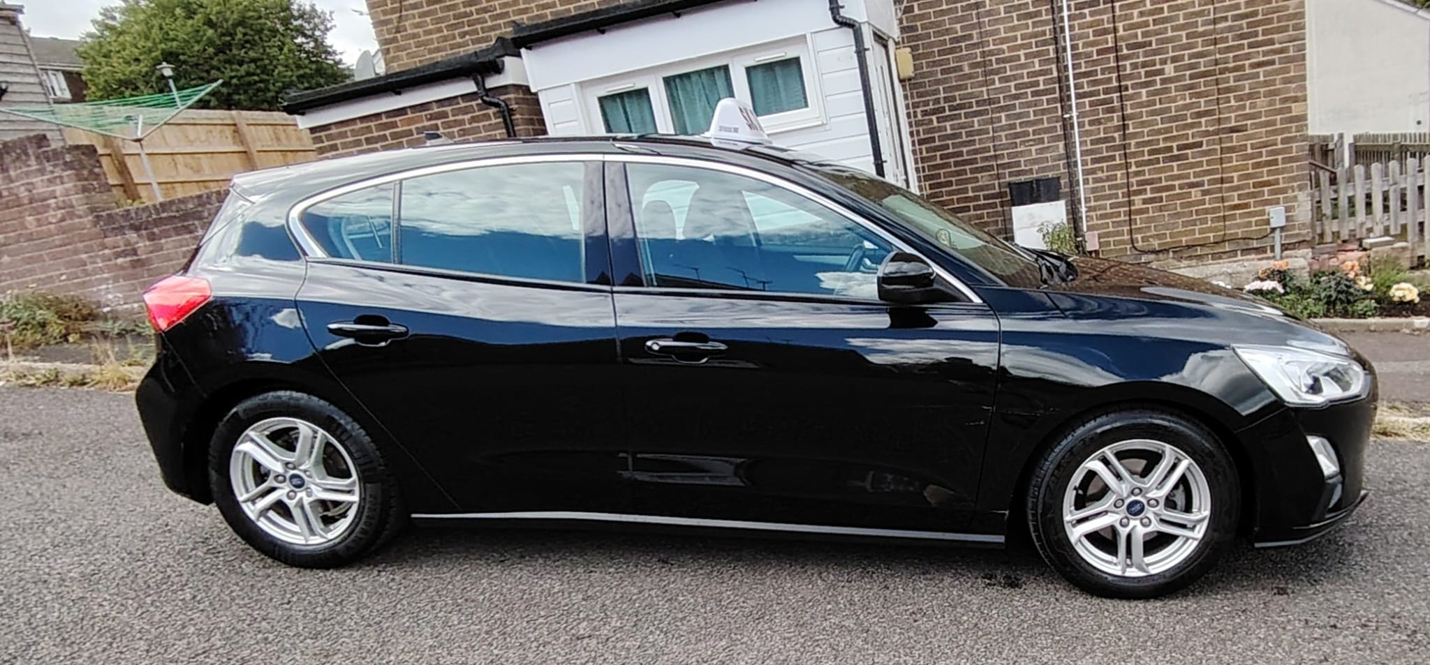 S K Taxis black sedan